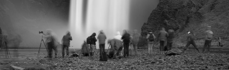 Mynd af fjölda ljósmyndara sem skyggja á Skógafoss